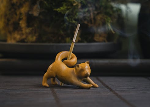 A clay sculpture of a fox serving as an incense holder, creating a calming ambiance indoors.