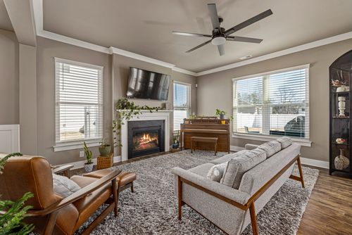 Free Warm and inviting living room featuring a fireplace, stylish furniture, and modern decor. Stock Photo