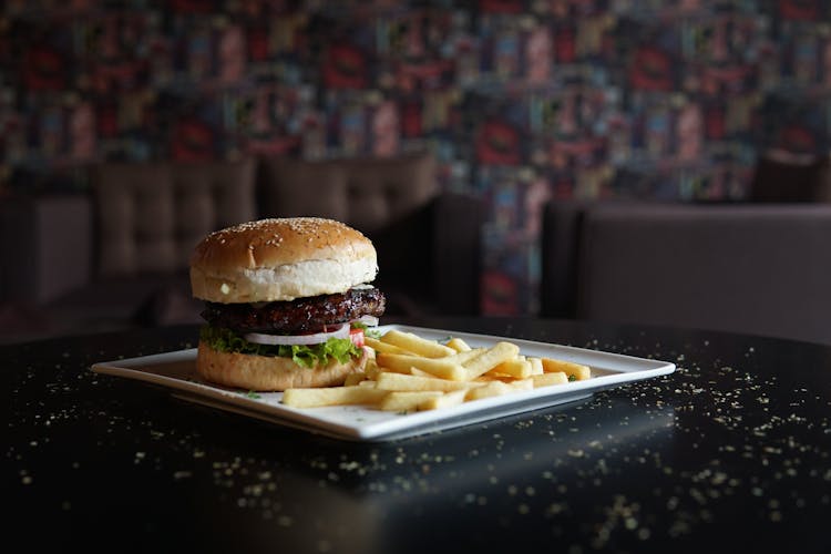 Burger And French Fries On White Tray In Restaurant