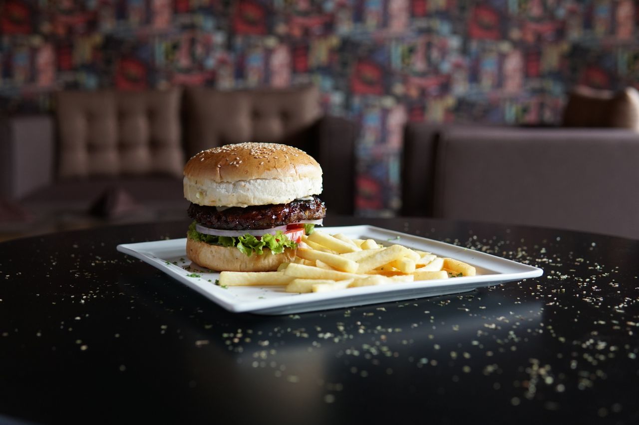 tasty burger with lettuce tomato and fries served on a stylish plate i