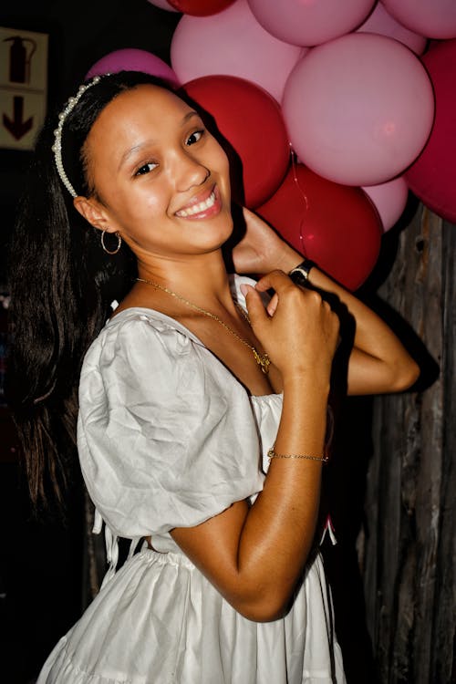 Woman Smiling and Wearing Dress and Jewelry