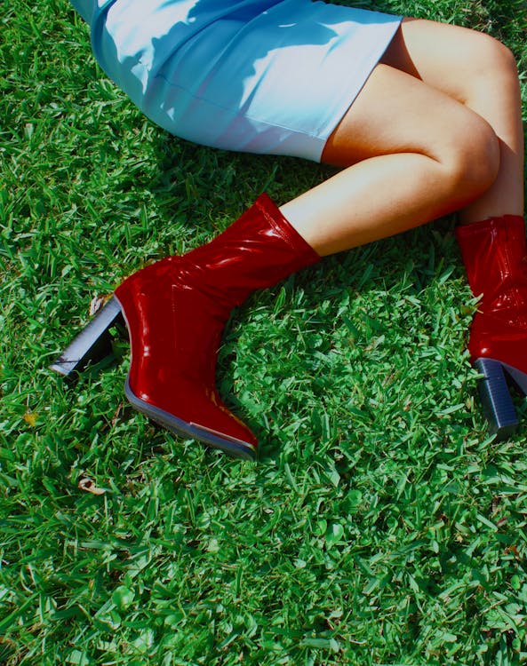 Woman in Blue Dress and Red Boots Sitting on Grass · Free Stock Photo