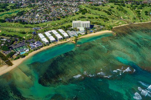 Free Stunning aerial view of Waikiki Beach showing the coastline, cityscape, and vibrant waters. Stock Photo