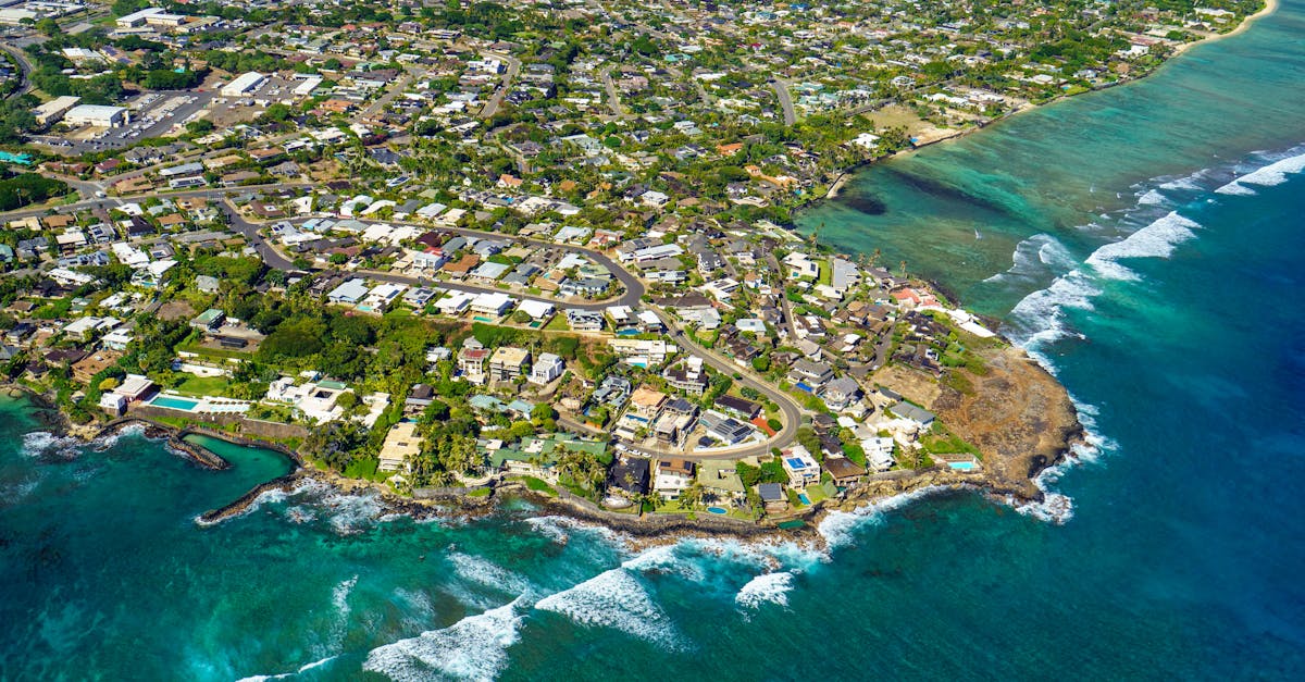 Photo by Cyrill Scenic aerial view of Honolulu's coastline, capturing vibrant tropical cityscape and crystal clear waters.