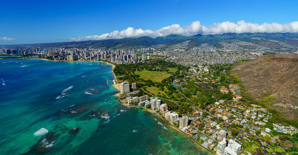 Stunning aerial view of Honolulu's coastline, showcasing the vibrant city and tropical beaches.