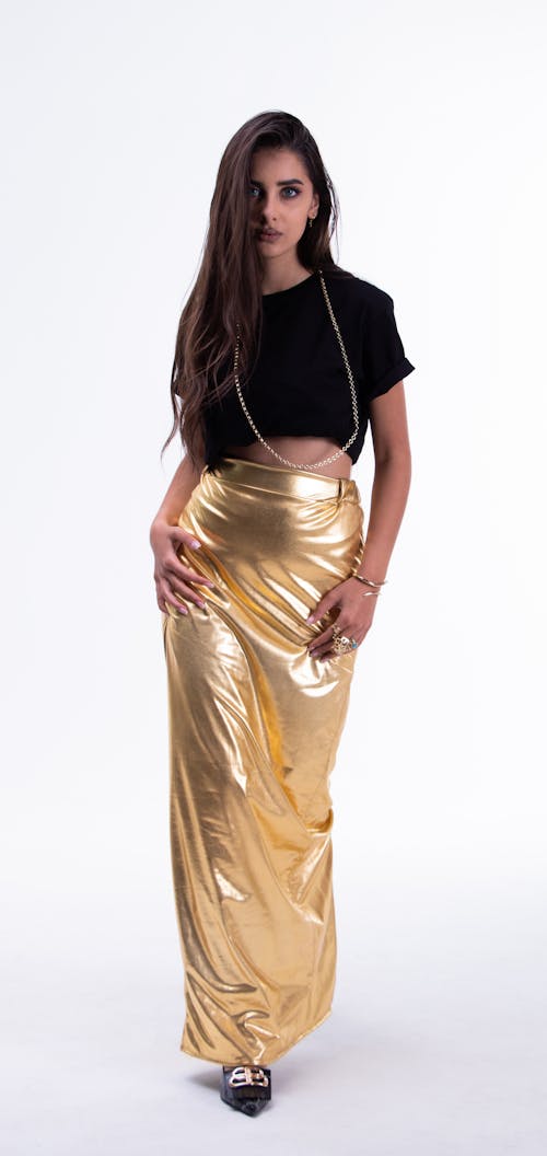 Young Woman Posing in Golden Long Dress