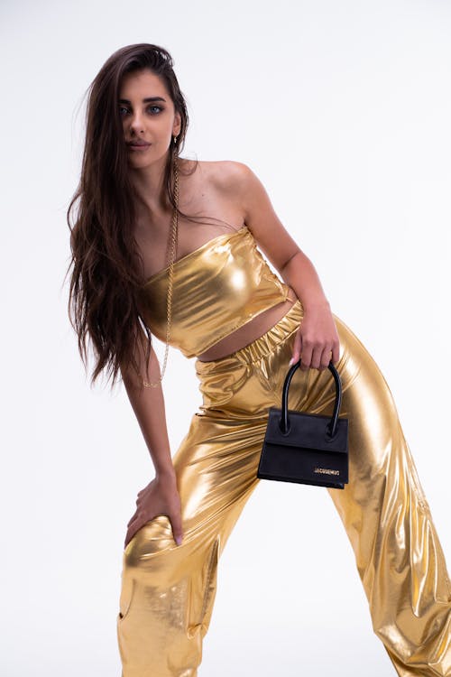 Woman Posing on Golden Pants and Tank Top