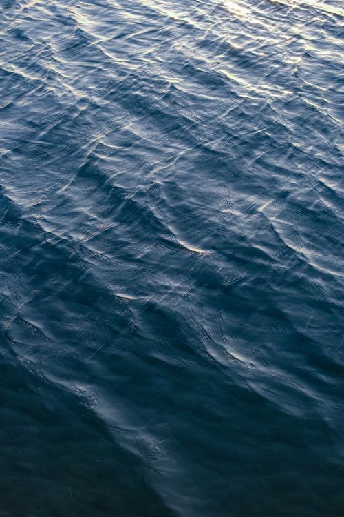 Free Close-up view of gentle ocean waves creating soothing patterns in natural light. Stock Photo