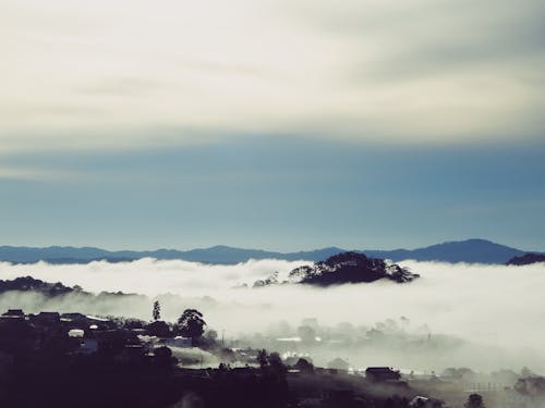 Blue Sky between Clouds over Village