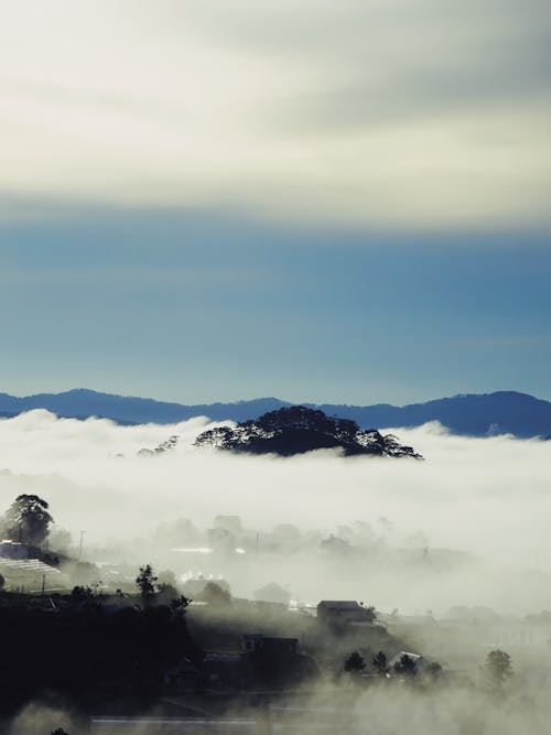 Mountain Village in Fluffy White Clouds