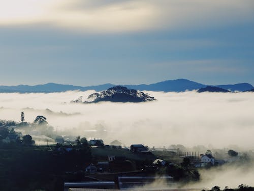 Blue Sky over Clouds over Village Houses