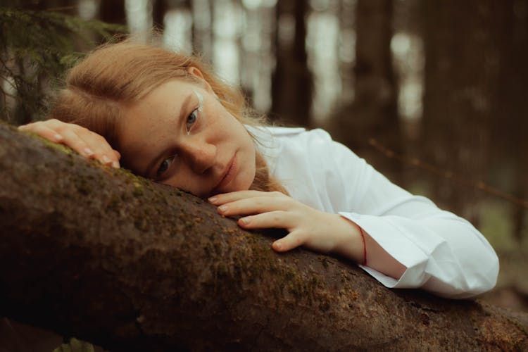 Redhead Woman Leaning On Tree