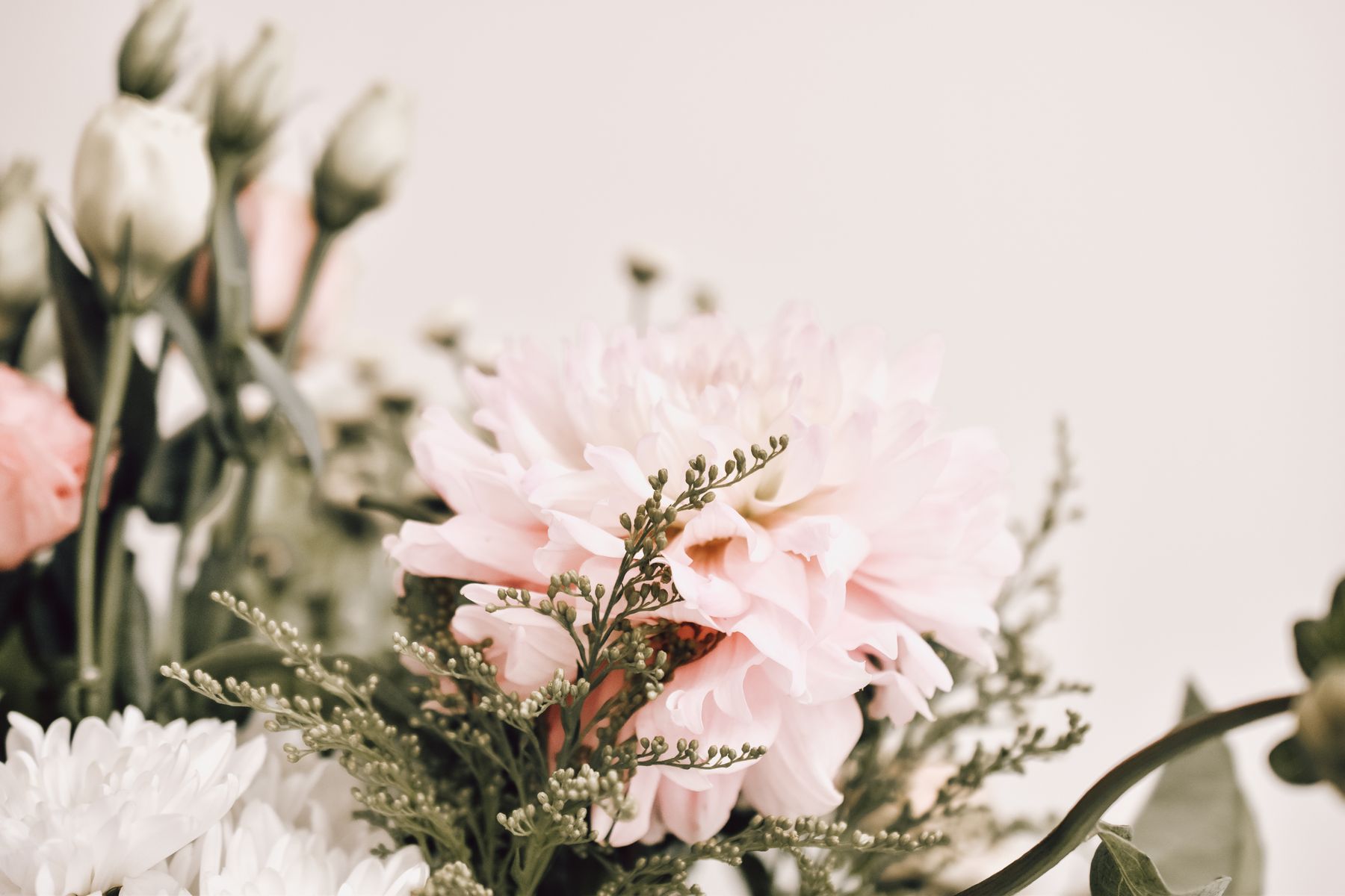 Close-up soft pastel pink bouquet with greenery