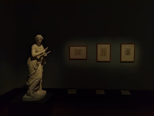 Antique Sculpture in Dark Room of Museum