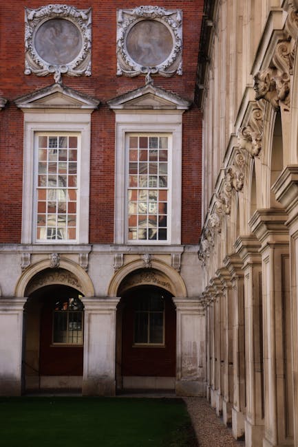 Ornate facade and arches of Hampton Court Palace, Molesey, England.