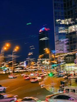 Dynamic night view of Kyiv's city streets with blurred lights and bustling traffic, capturing urban energy.