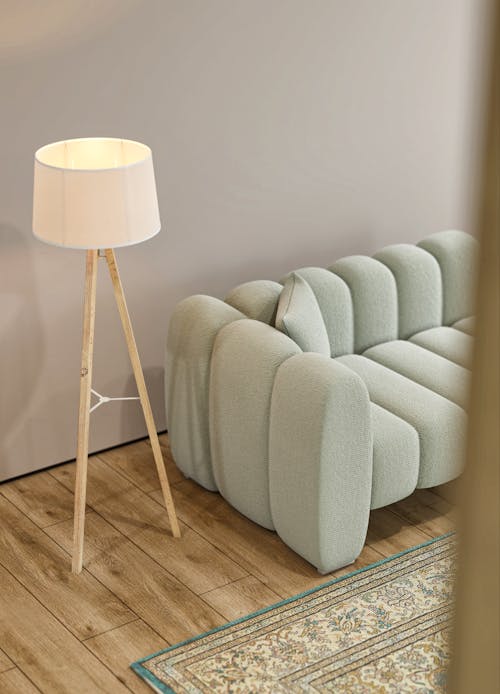 Lamp by Sofa on Wooden Floor