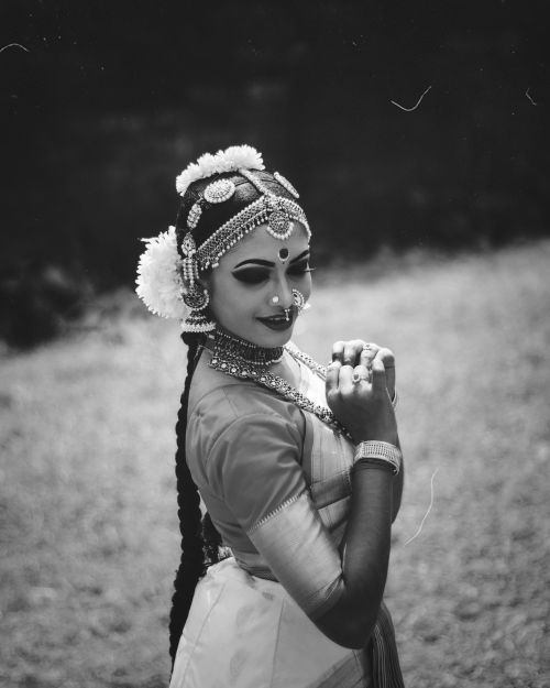 Free A stunning black and white portrait of a traditional Indian dancer showcasing intricate makeup and jewelry. Stock Photo