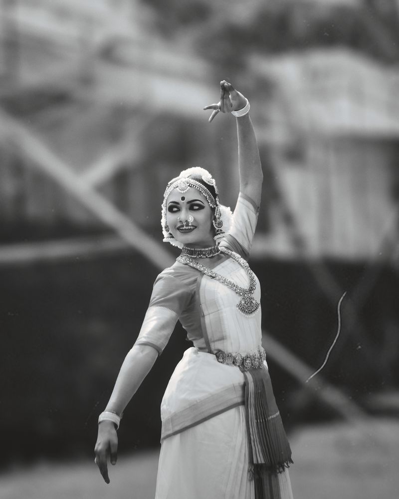 Young woman in traditional attire performing a graceful dance