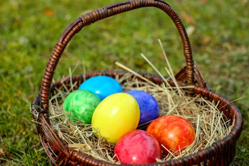 Wicker Basket with Easter Eggs on Hay