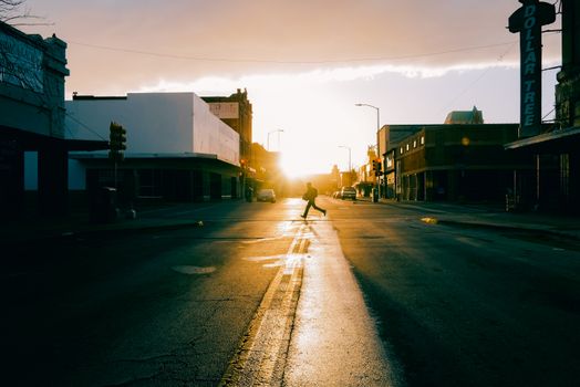 Silhouette of Man Crossing Street at Sunset