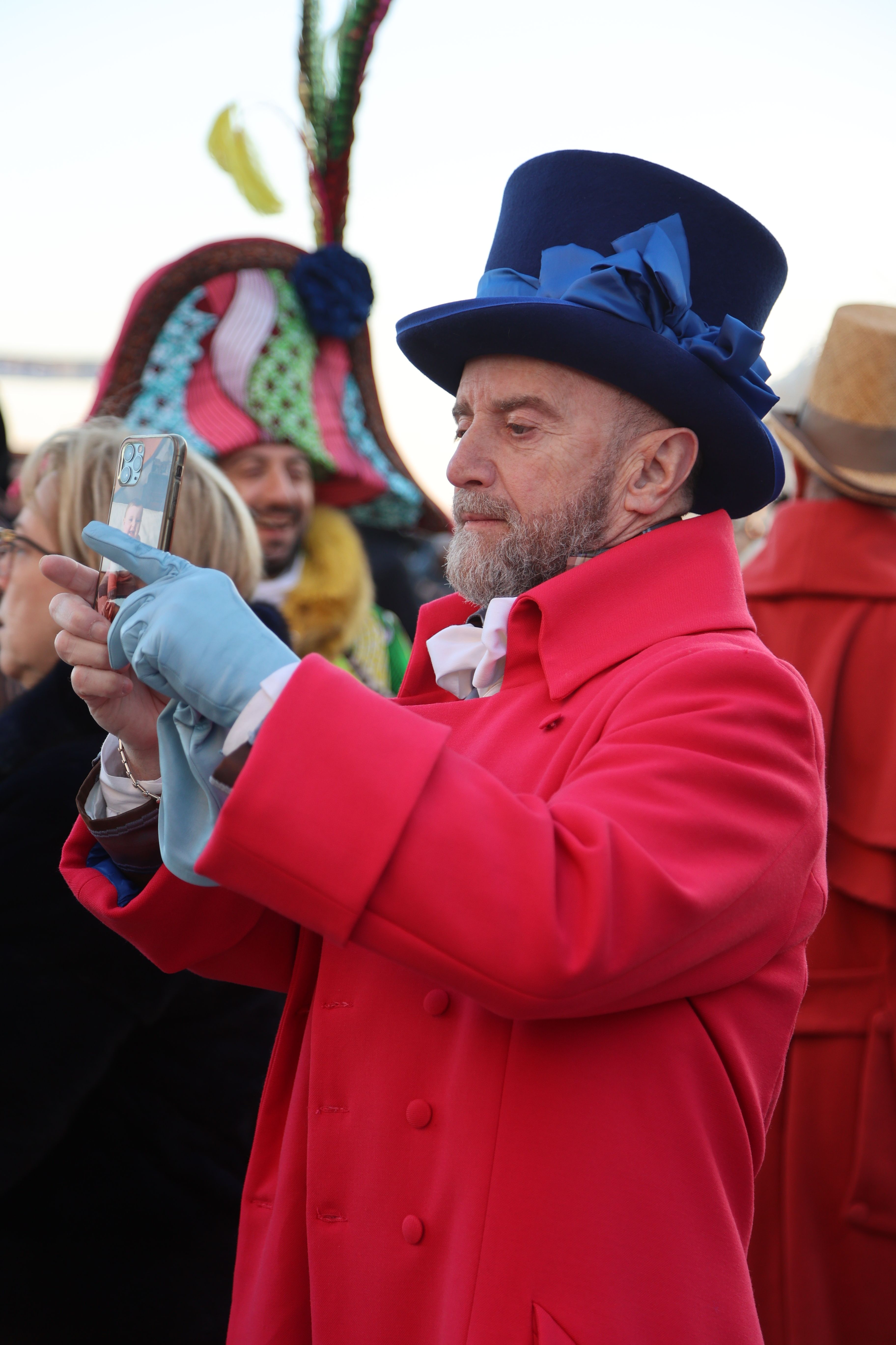 A man in a red coat and top hat taking a picture · Free Stock Photo