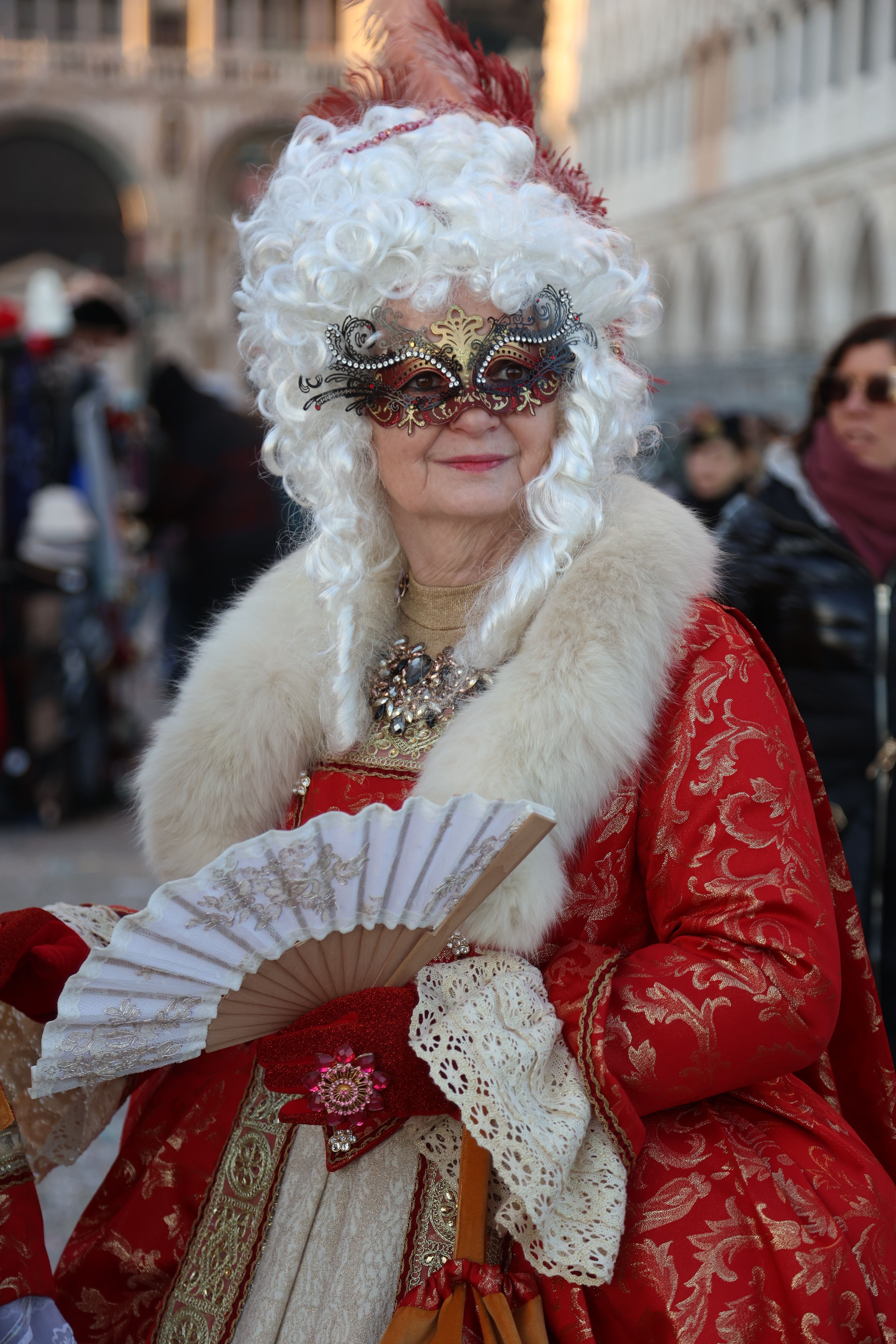 A woman in a red and white costume with a fan · Free Stock Photo
