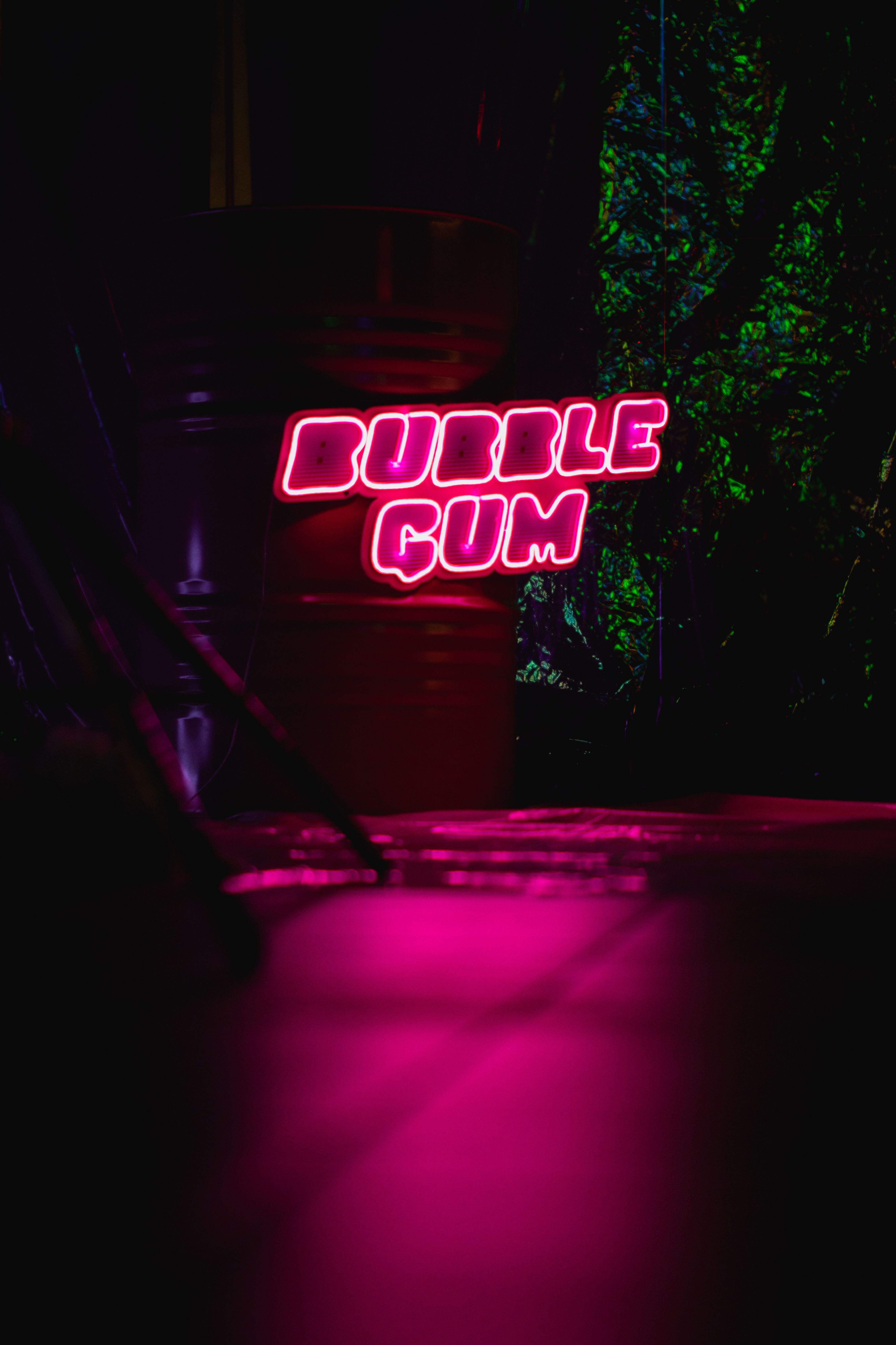 Vibrant neon sign glowing in the dark, spelling 'Bubble Gum'. Perfect for urban and nightlife themes.
