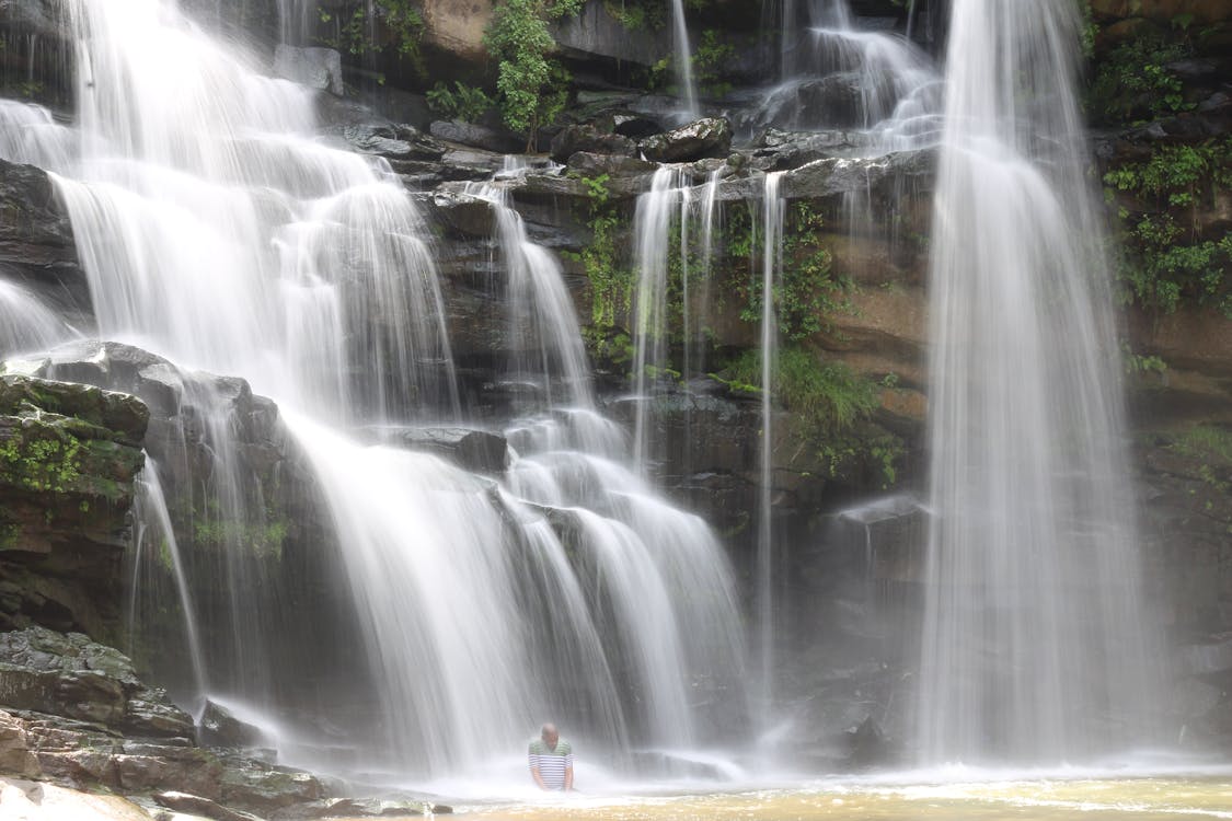 man-in-scenic-waterfall