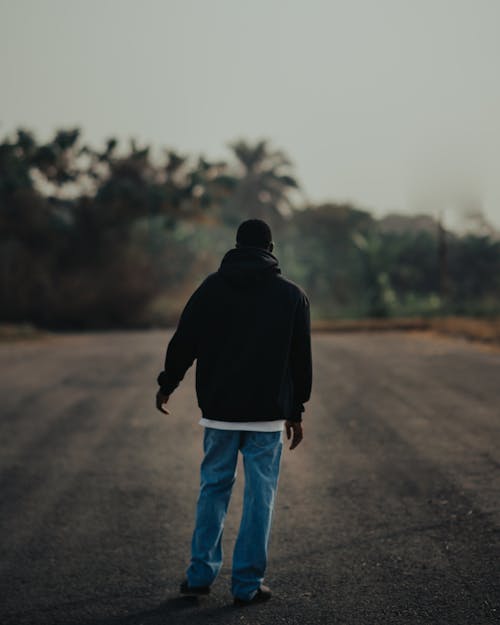 Man in Jacket Standing on Road