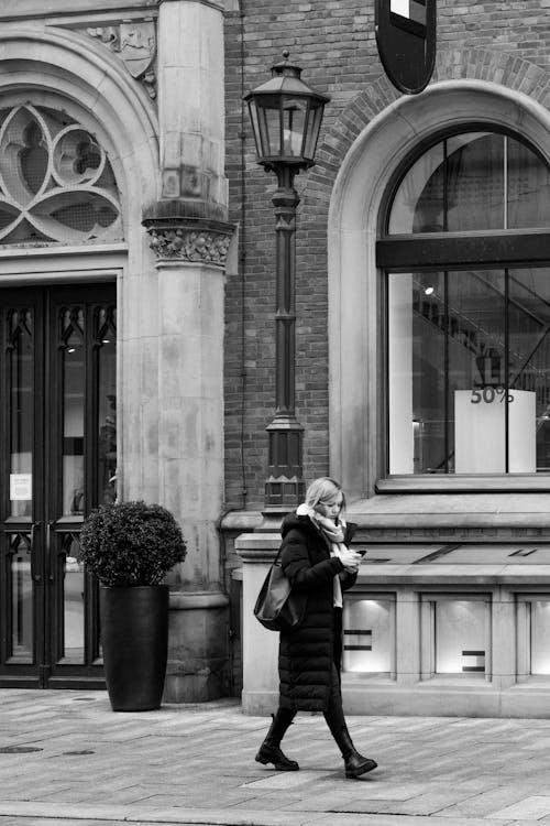 Woman in Coat Walking in Town