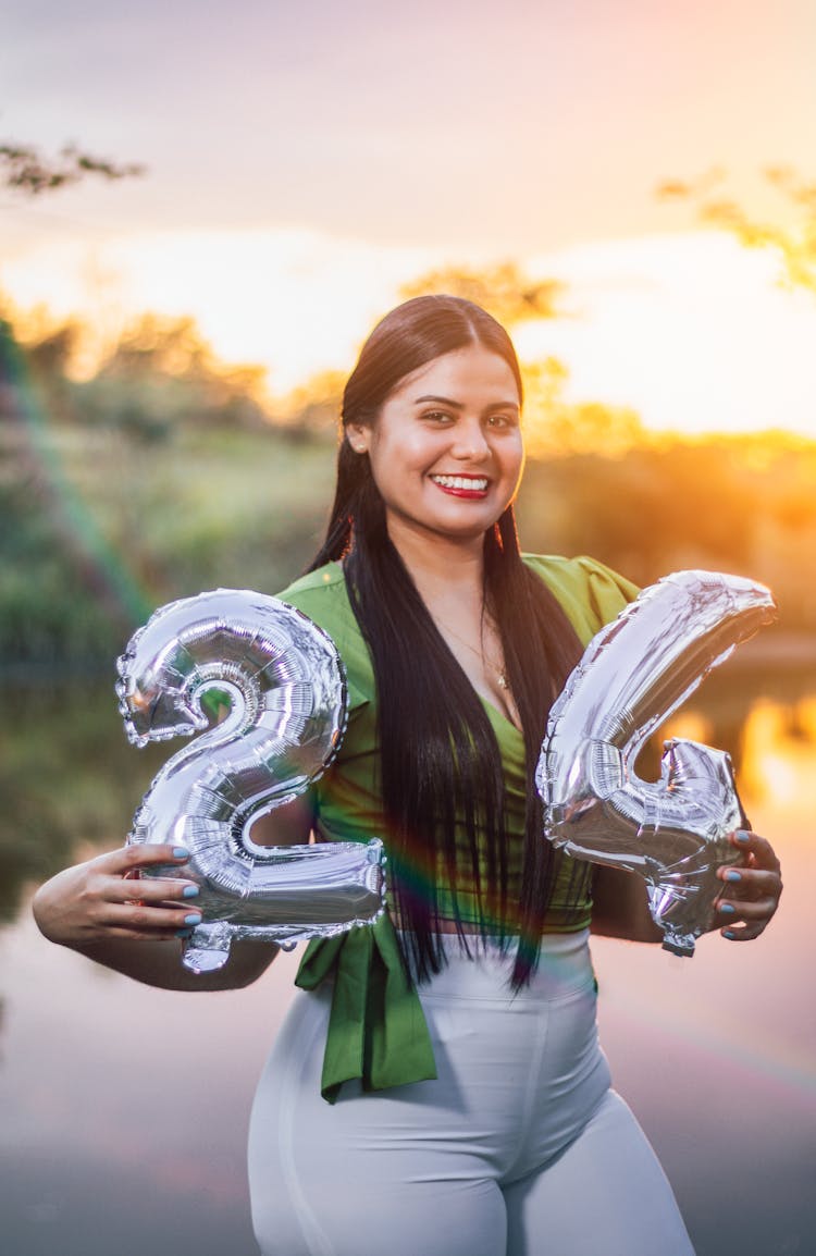 Smiling Woman Holding Digit Balloons 24