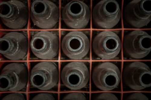 Free Top view of vintage clay bottles stacked in a grid pattern, offering an artistic perspective. Stock Photo