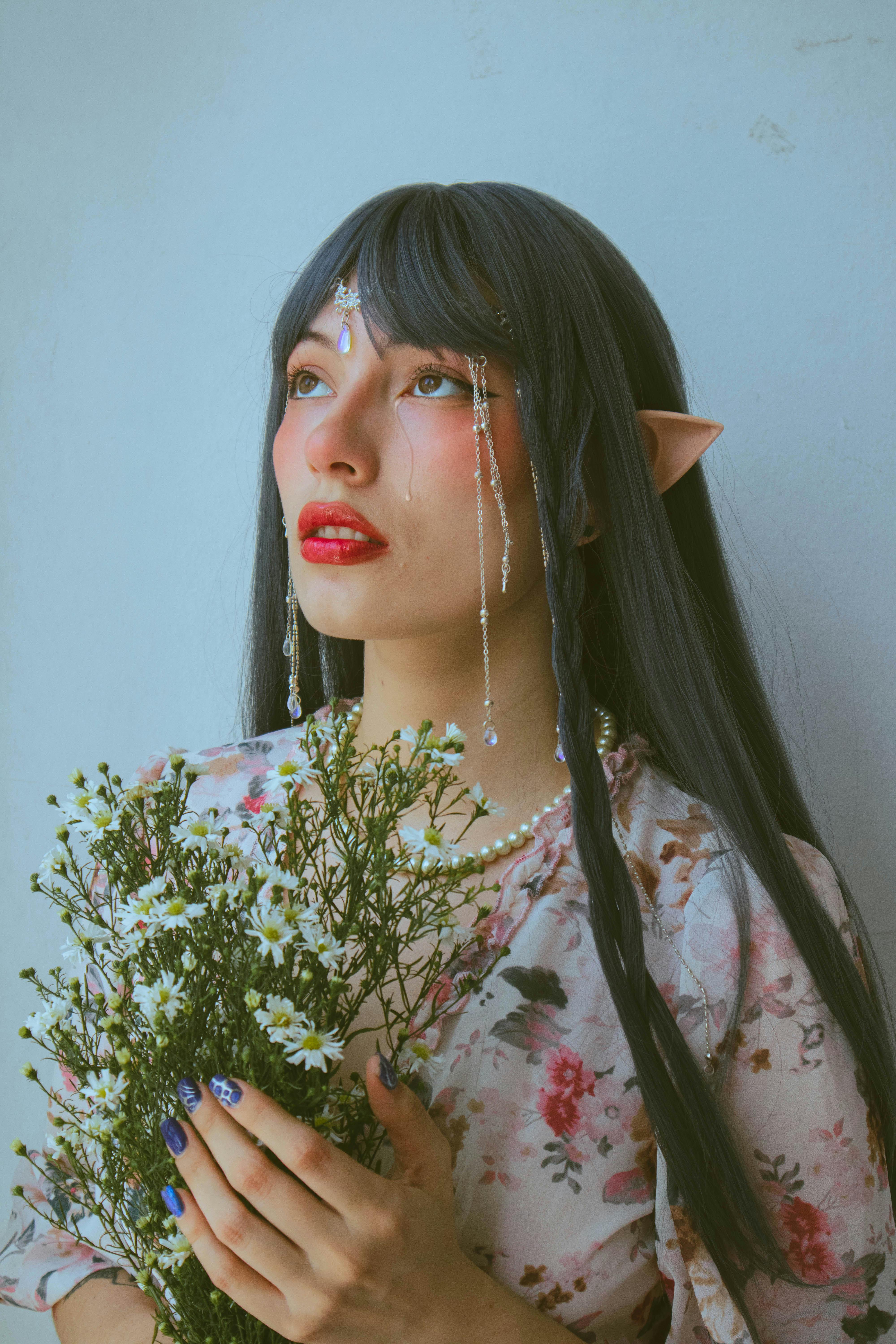 woman with elf ears posing with flowers