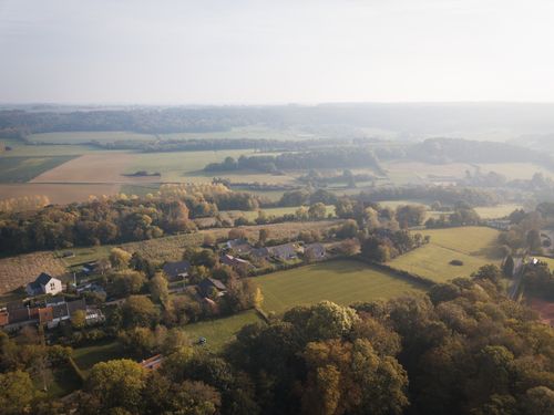 Free Scenic aerial drone view of a serene countryside landscape featuring fields, forests, and houses during daylight. Stock Photo