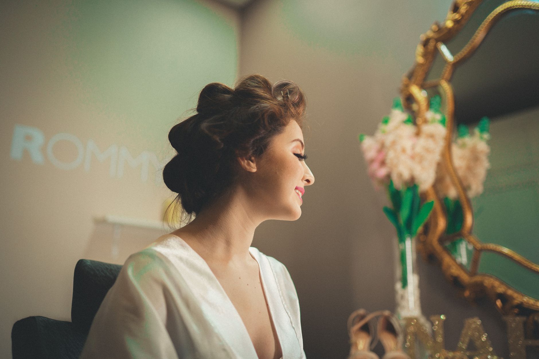 Elegant beauty salon moment with a woman in front of a vintage mirror