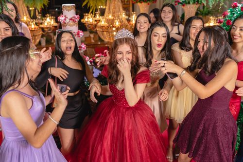 Free A young girl celebrates her quinceañera surrounded by friends, laughter, and vibrant dresses. Stock Photo