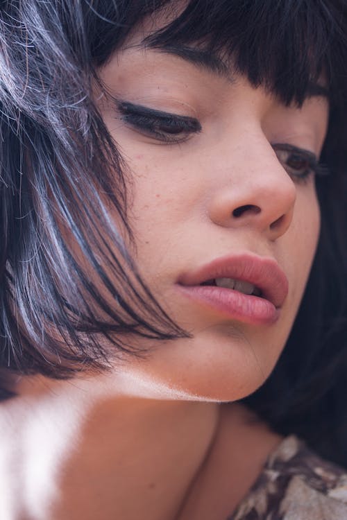 Woman Wearing Black Mascara and Eyeliner Pouting Lips