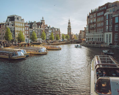 The Amstel Canal and the View of Westerkerk Church in Amsterdam, the Netherlands 