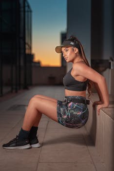 Athletic woman exercising outdoors at sunset, capturing urban fitness vibes.