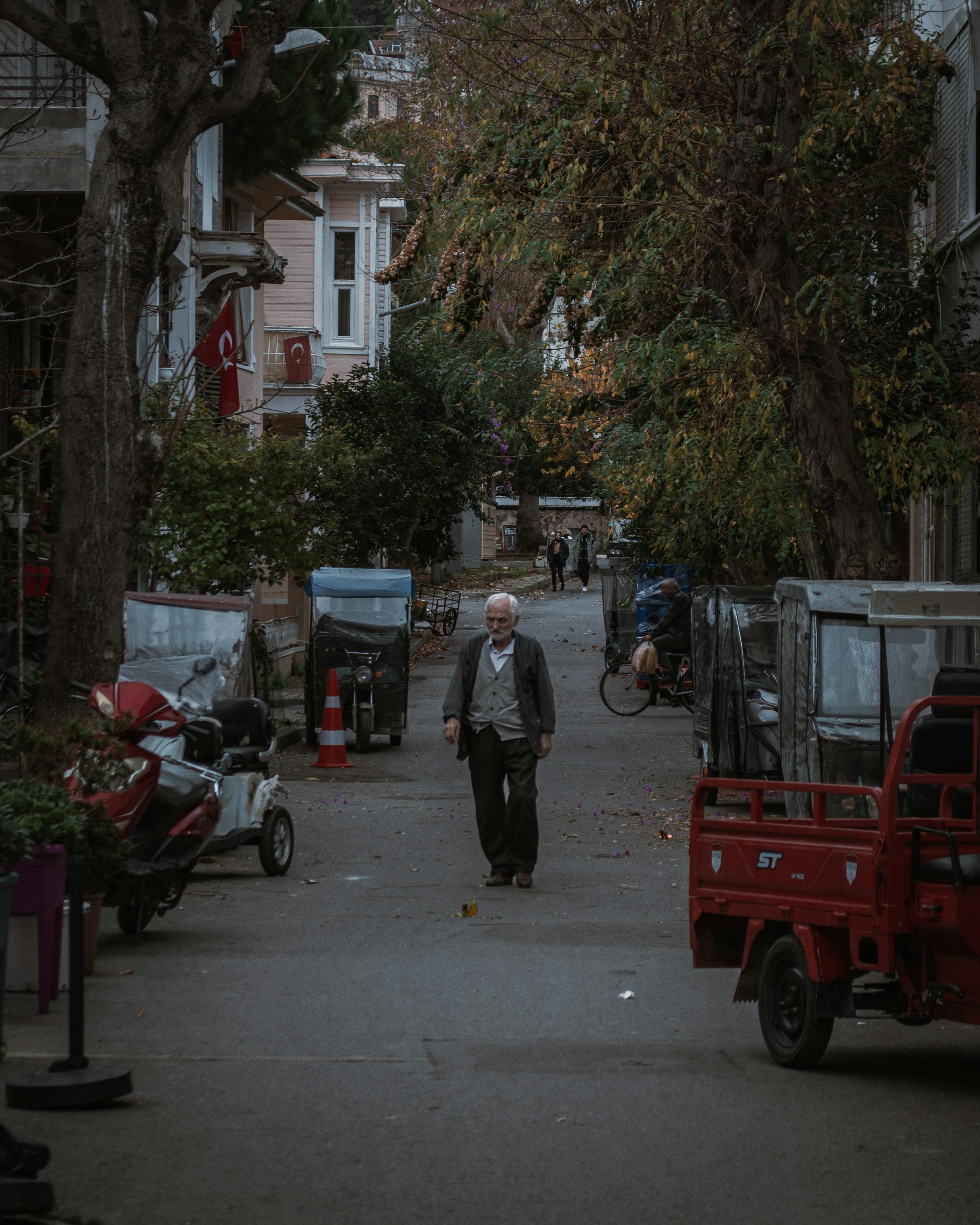 A serene street scene in Istanbul with an elderly man walking, showcasing Turkey's urban life.