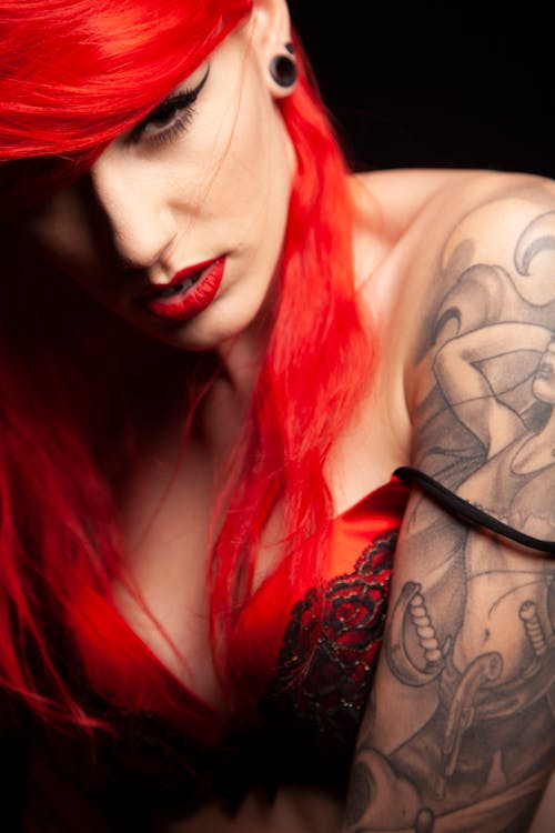 Red Haired Woman with Tattoos on her Body 