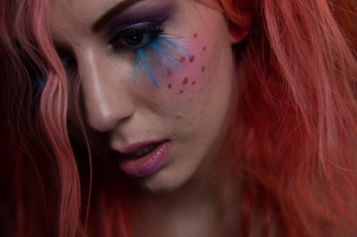 Beautiful Woman with Blue Feathers on Face