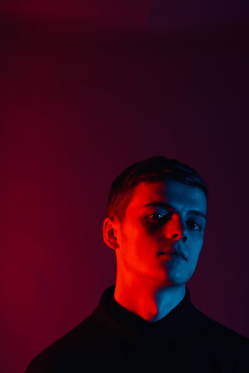 Man Standing Near Red Wall