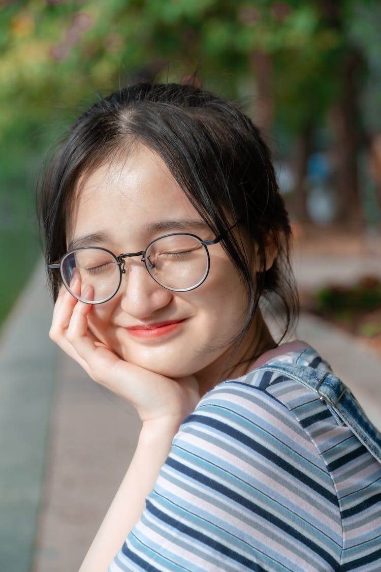 Smiling Girl In Glasses Outdoors