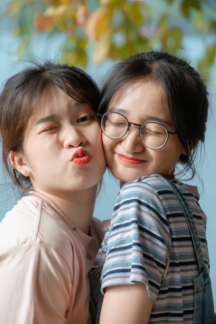 Portrait Of Smiling Girls Hugging Outdoors