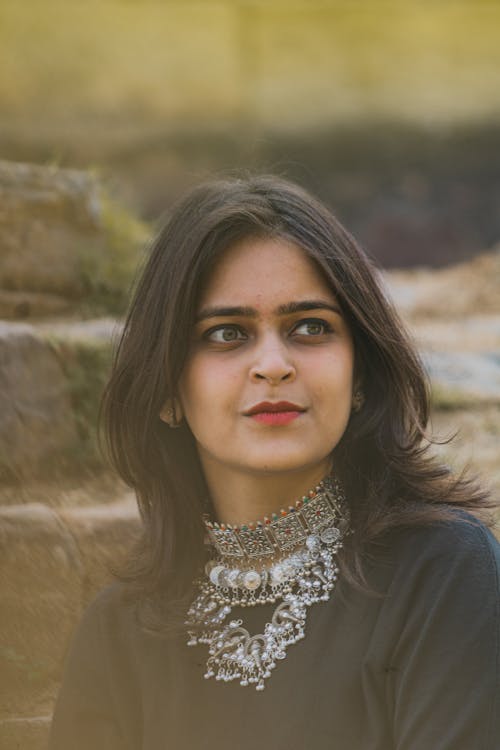 Brunette Woman in Black Blouse with Necklace