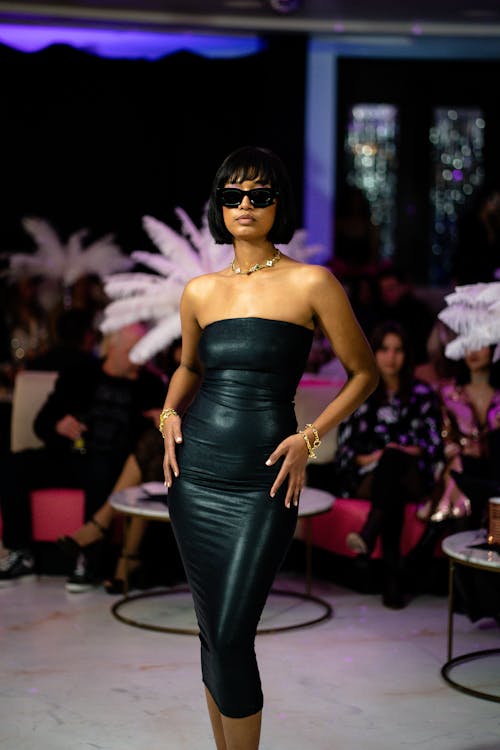 Young Woman in a Black Dress on a Fashion Show 