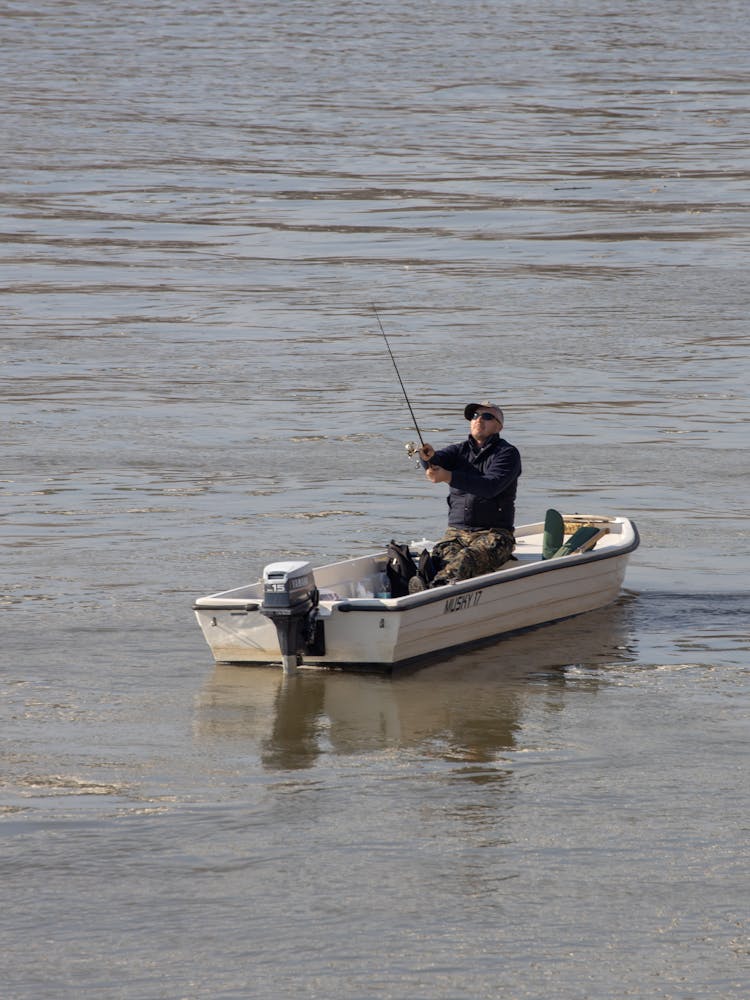 Fisherman On Motorboat