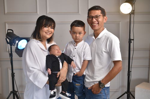 Parents with Two Sons Posing for a Family Picture 